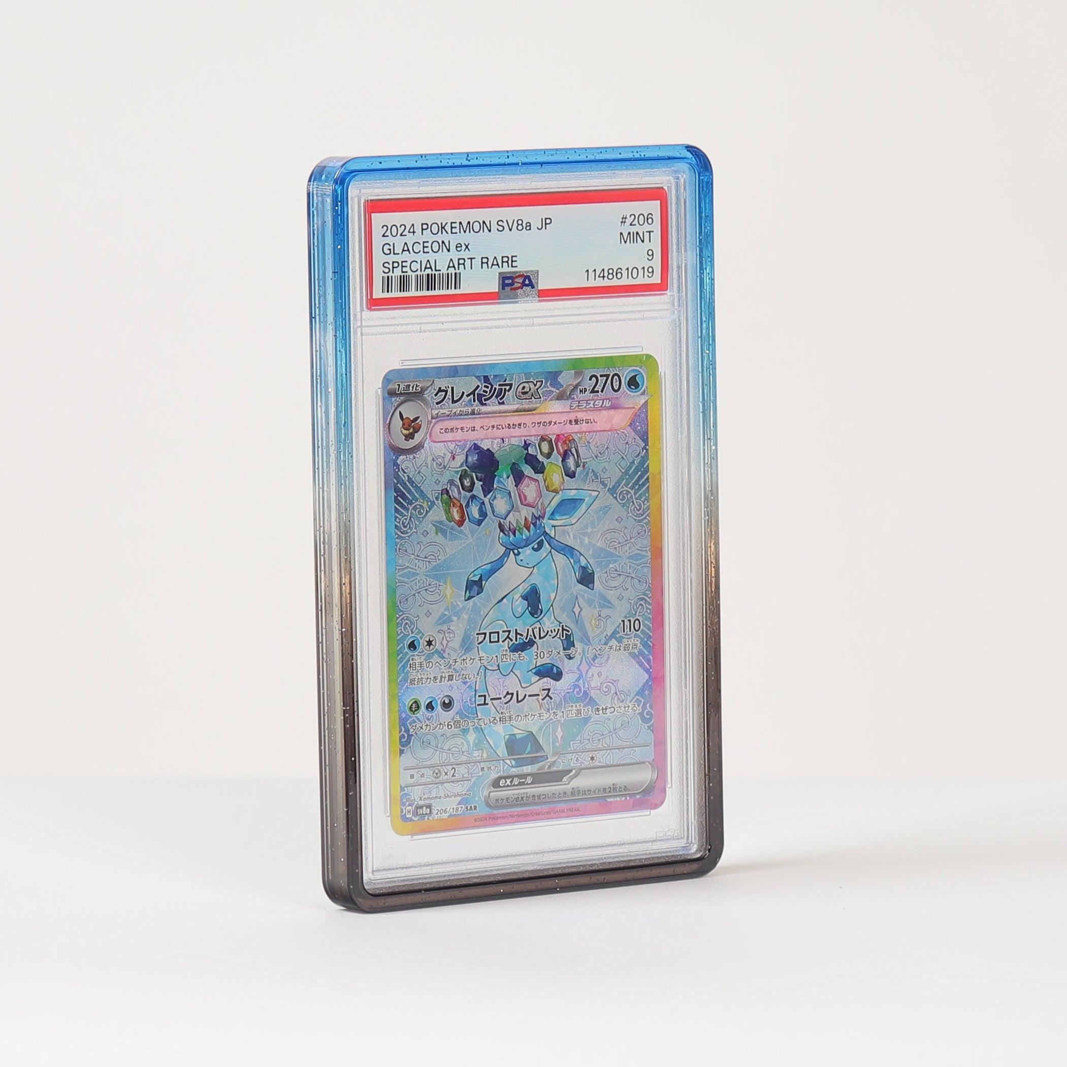 A graded holographic Pokémon card in a clear PSA-style slab, standing upright on a white surface against a white background.