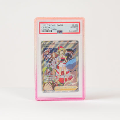 A graded holographic Pokémon card in a pink PSA-style slab, standing upright on a white surface against a white background.
