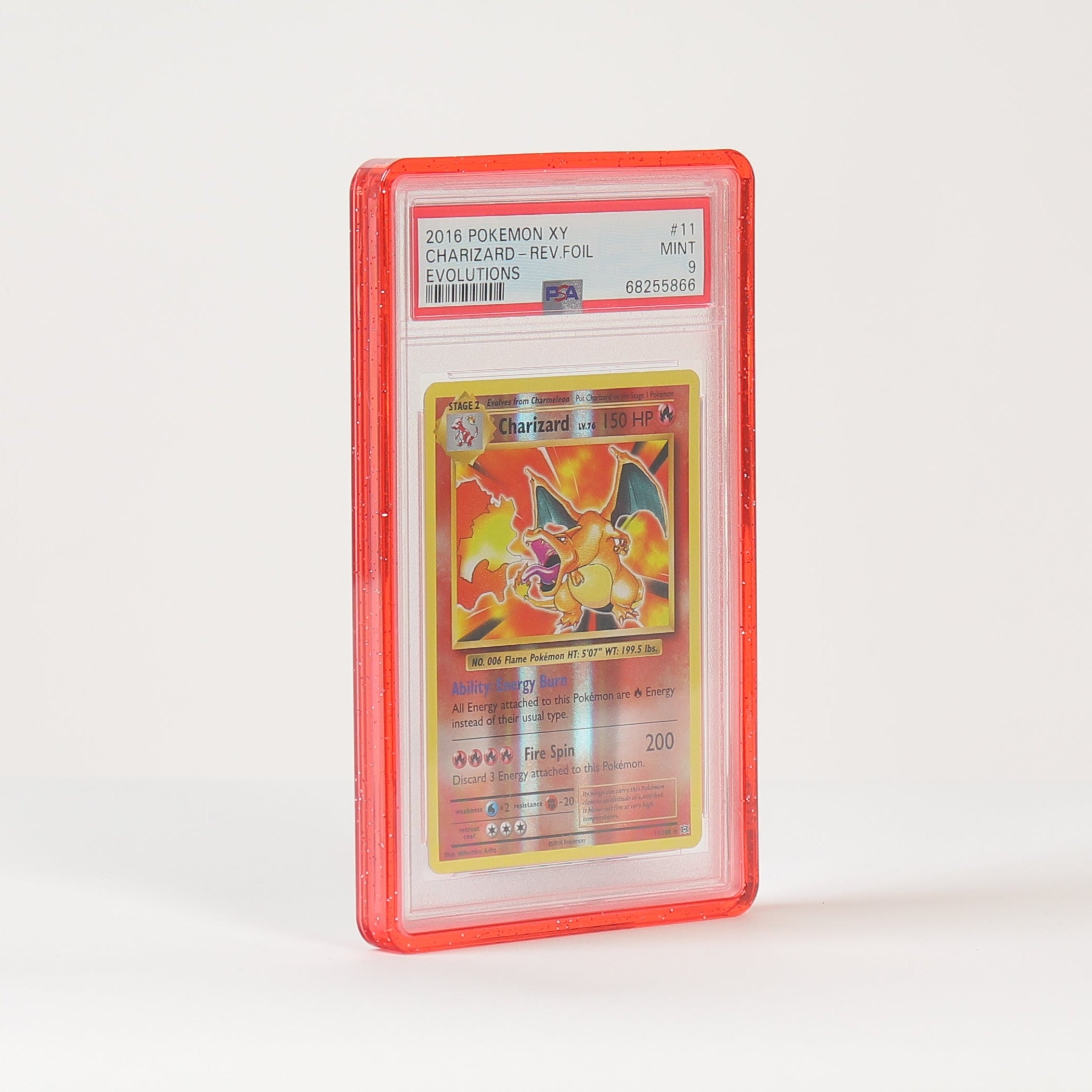 A graded Pokémon TCG card in a clear PSA-style slab with a red border, standing upright on a white surface against a white background.